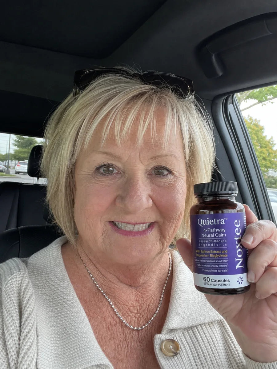 Woman holding a bottle of Quietra in her car