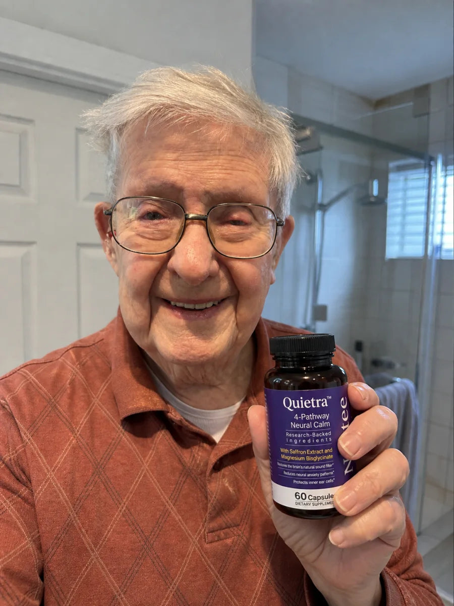 Man holding a bottle of Quietra at home