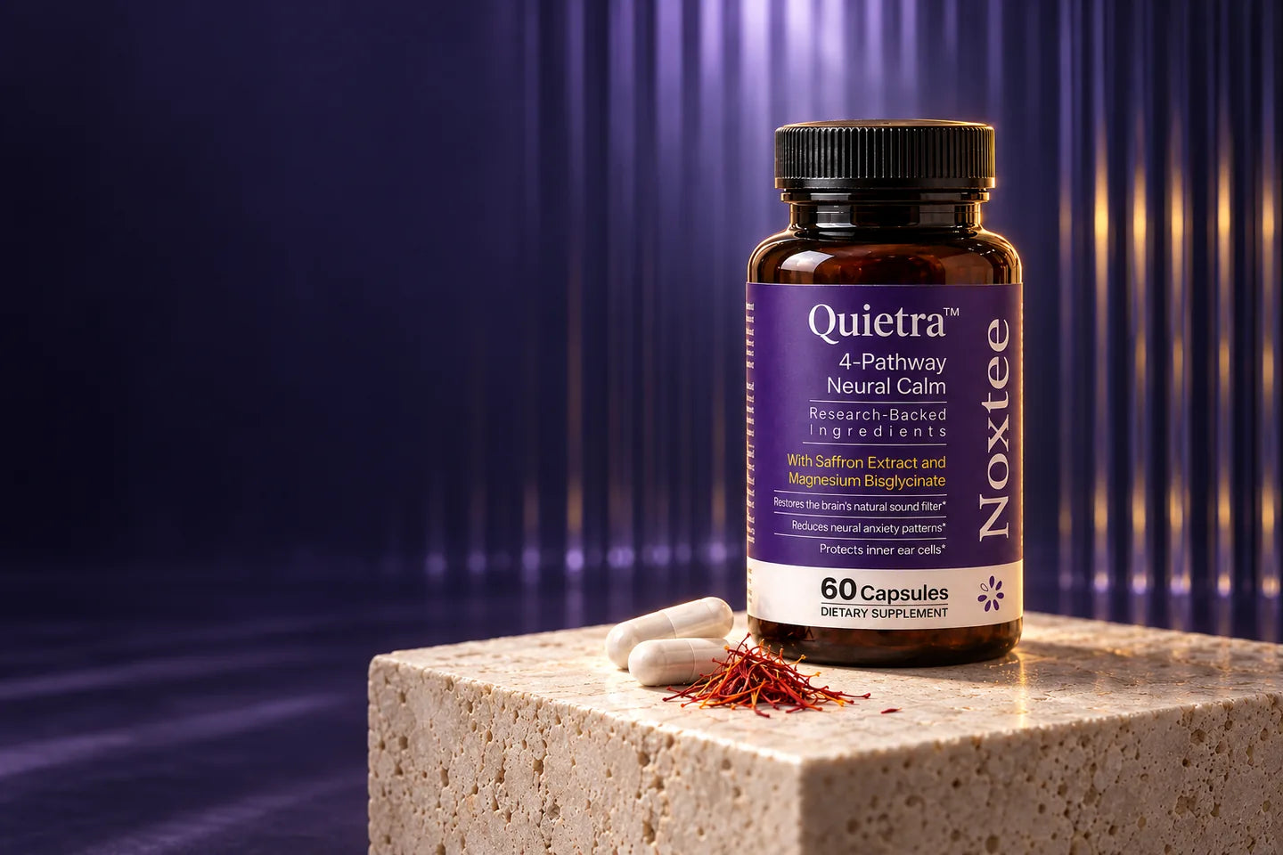 Quietra by Noxtee bottle on a travertine plinth with two white capsules and saffron threads